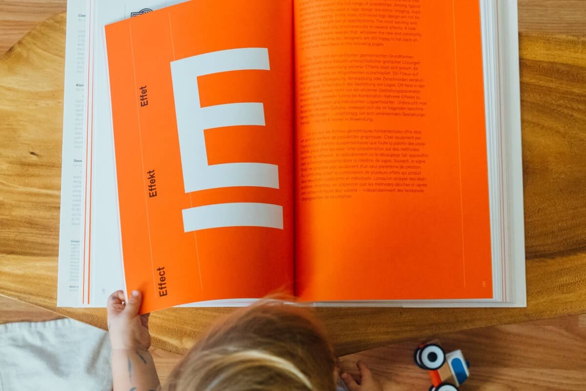 Child Reading an Orange Book Child Reading an Orange Book